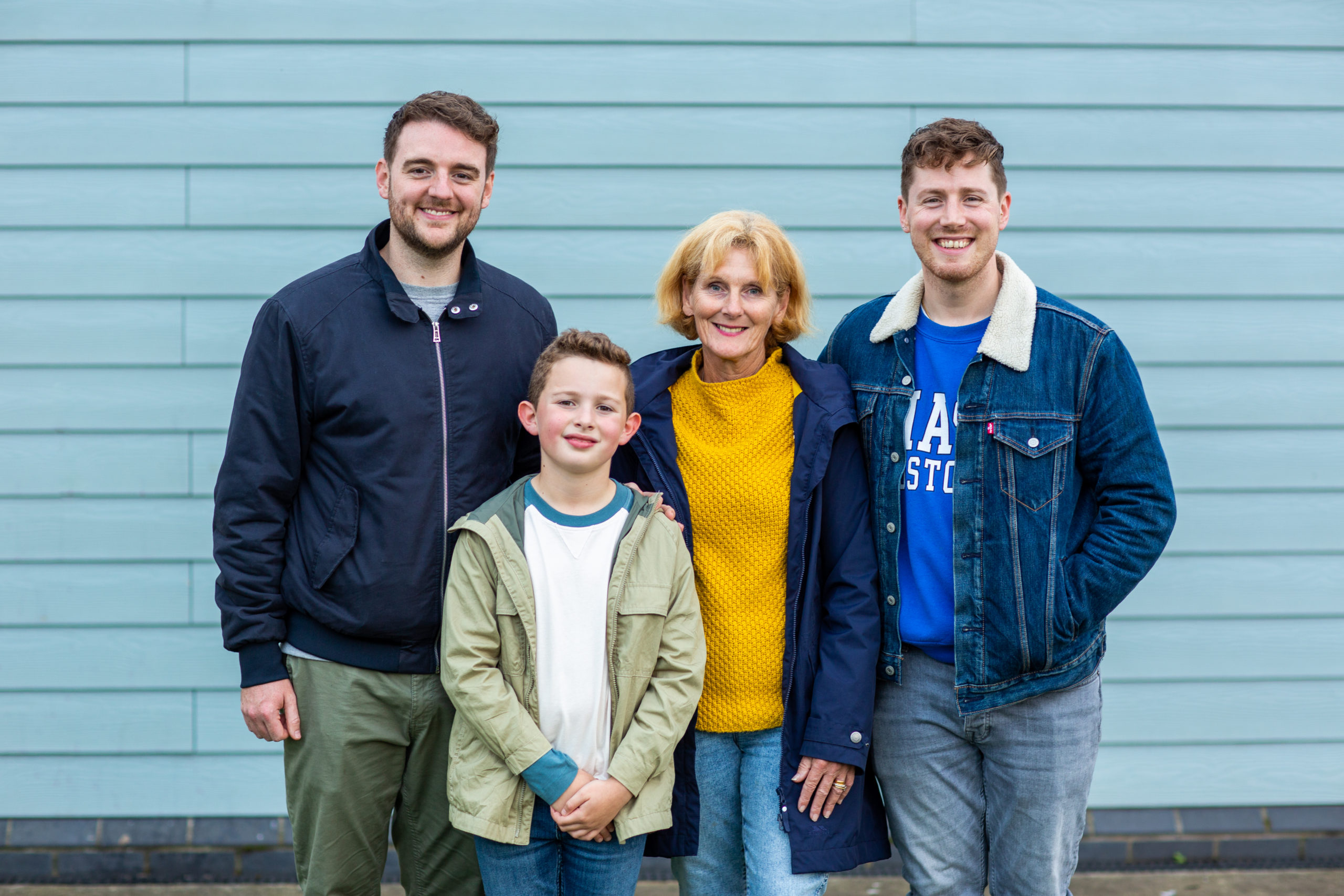 A family standing and smiling